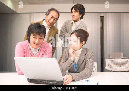 Four people discussing in office Stock Photo