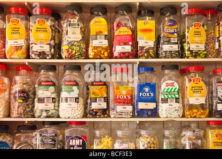 Jars of sweets on shelves at a traditional sweet shop in the Uk Stock Photo