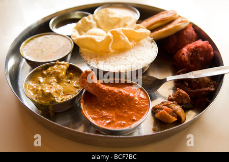 A traditional Indian thali (sometimes known simply as a meal) is served. This is a non-vegetarian thali. Stock Photo