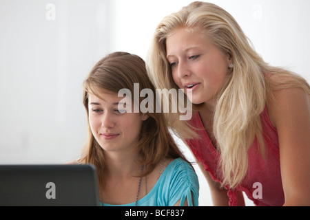 Two teenage girls behind a laptop Stock Photo