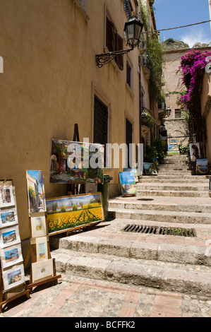 Paintings for sale on side street steps in Taormina, Sicily Stock Photo