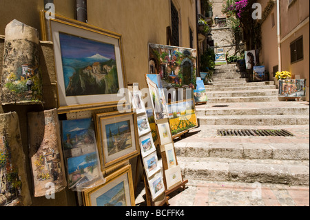 Paintings for sale on side street steps in Taormina, Sicily Stock Photo