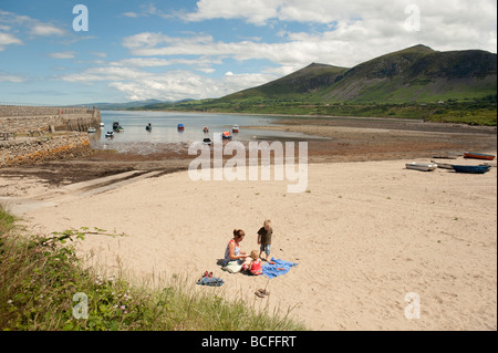 A young family on the beach at Trefor on the north coast of the Lleyn Peninsula wales UK summer afternoon Stock Photo