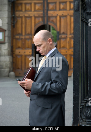 businessman text on mobile phone Stock Photo