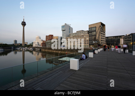 view from footbridge across Dusseldorf mediaharbor to Rhine tower and marina Stock Photo