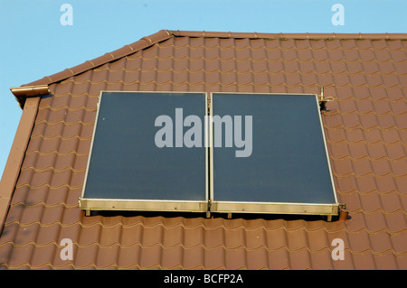 Flat-plate solar collector on the roof Stock Photo