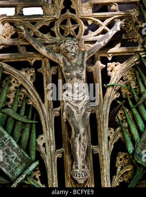 The weathered figure of Jesus on the gate of a family tomb. Stock Photo