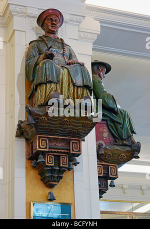 Asian statues inside the famous Les Deux Magots café Paris France Stock Photo