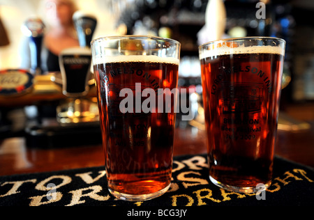 Pints of Harveys beer on the bar at The Lord Nelson Inn in Trafalgar Street Brighton Sussex UK Stock Photo