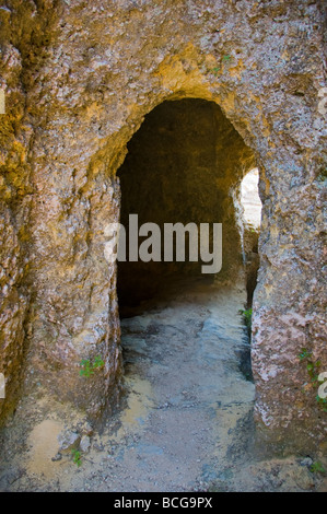 Entrance to tomb in Mycenaean Cemetery carved from solid rock in 1500BC at Mazarakata on the Greek island of Kefalonia Greece GR Stock Photo