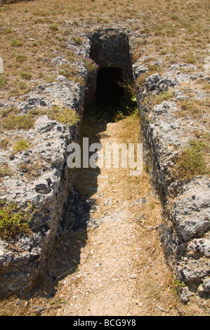 Entrance to tomb in Mycenaean Cemetery carved from solid rock in 1500BC at Mazarakata on the Greek island of Kefalonia Greece GR Stock Photo