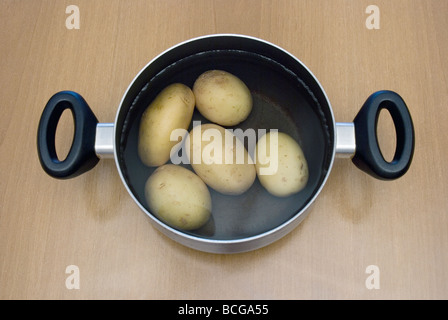 potatoes in a pan with water Stock Photo