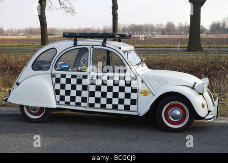 chequered Citroen deux chevaux parked by roadside Stock Photo