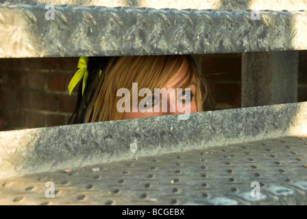 Goth Emo Girl Looking Through a Metal Staircase Stock Photo