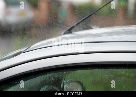 Heavy rain on car roof Stock Photo