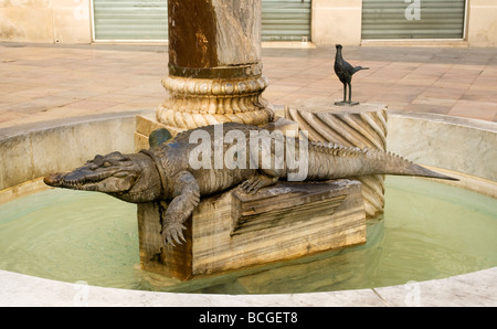 Fountain with crocodile statue in city of Nimes, France Stock Photo