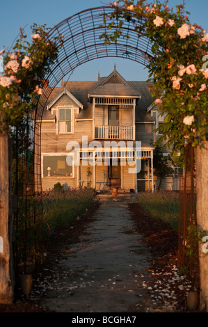 An old victorian home in need of some renovation stands watch over the Strait of Georgia on Lummi Island, Washington. Stock Photo