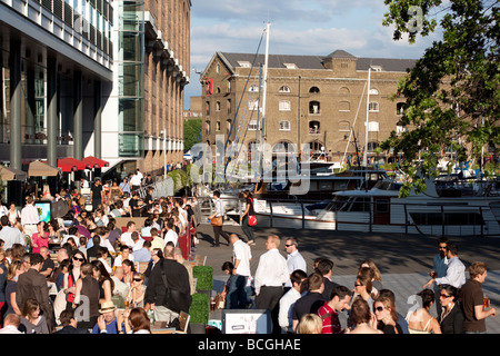 The busy evening cafe scene in summer at St Katharine Docks London Stock Photo