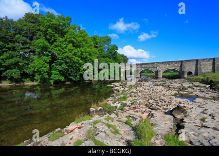 Bridge over River Wharfe and limestone pavement near Grassington, Yorkshire Dales National Park, North Yorkshire, England, UK. Stock Photo