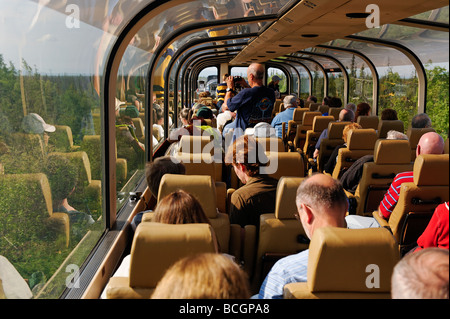 Tourists enjoy panoramic views aboard a double decker train car on the Alaska Railroad system Alaska Stock Photo