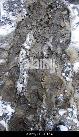 footsteps through muddy snow Stock Photo