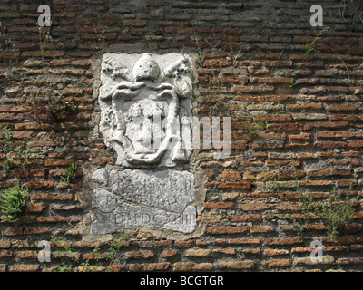 old papal carving on street wall in rome, italy Stock Photo