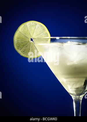 Martini glass with iced cocktail garnished with a lime wheel Stock Photo