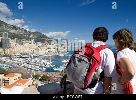 Couple of tourists (man and woman) viewing Port de Monaco Monte Carlo from an elevated position Stock Photo