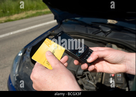 Close up of somebody using a mobile phone to ring the aa automobile association following a car breakdown Stock Photo