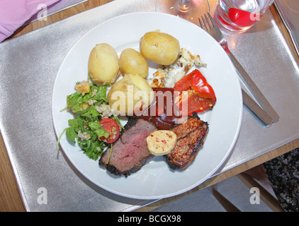 Sweden typical swedish traditional bbq dinner plate of  fillet of beef and pork meat with fresh picked potatoes and sallad Stock Photo