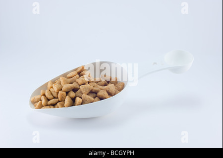 one scoop of dog food isolated on white Stock Photo