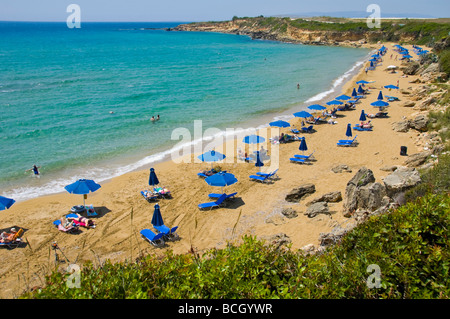 Tourists relaxing on sunbeds under umbrellas on the small sandy Ammes beach on the Greek island of Kefalonia Greece GR Stock Photo