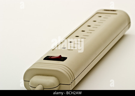 A surge suppressor with multiple outlets for plugs and a red switch Stock Photo