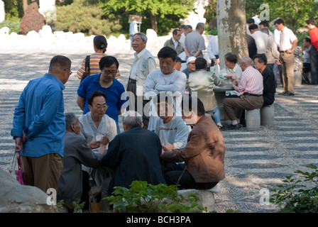 Groups of people playing cards at Fuxing Park Shanghai China Stock Photo