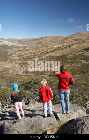 Family Looking over Snowy River from Snow Gums Board Walk Charlotte Pass Kosciuszko National Park Snowy Mountains NSW Australia Stock Photo
