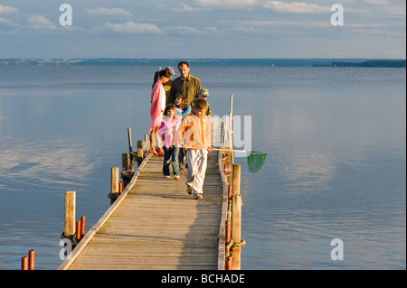 People relax on wooden pier overlooking Puck Bay Hel Peninsula Baltic Sea Poland Stock Photo