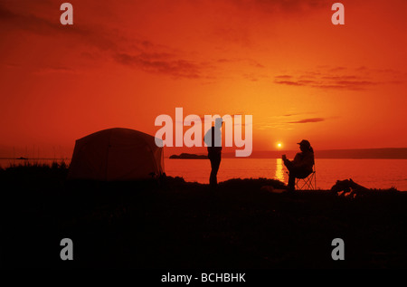 Kachemak Bay near Homer Sunset Campers by tent AK Southcentral Summer Scenic Silhouette Stock Photo