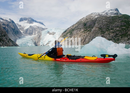 Male kayaker paddles towards Northwestern Glacier in Kenai Fjords National Park Southcentral Alaska summer Stock Photo