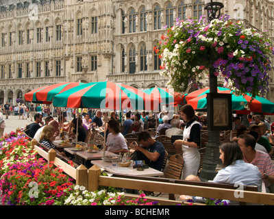 people having a drink and enjoying the 17th century scenery on the Grote Markt main square in Brussels Belgium Stock Photo