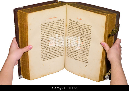 Old big book with hard cover is open. Isolated over white. Stock Photo