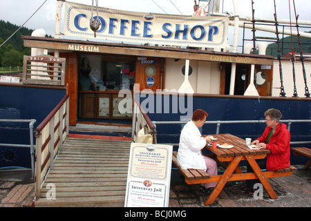 2 women sitting outside the Coffee Shop at the Maritime Museum, 'The Arctic Penguin' on Inverary Pier, Argyll, Scotland Stock Photo