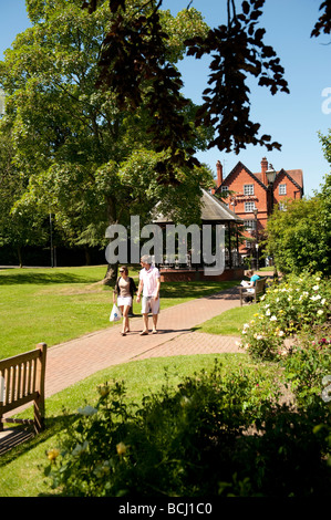 A young couple walking in the park on a summer morning Llandrindod Wells Powys UK Stock Photo