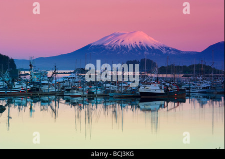 Alpenglow sunrise on Mt. Edgecumbe and the small boat harbor in Sitka, Alaska Stock Photo