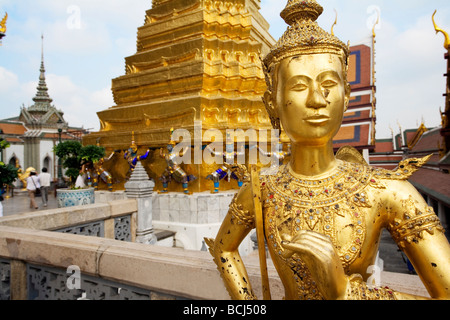 Golden statue within the gates of the Grand Palace in Bangkok Thailand Stock Photo