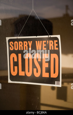 Sign in retail shop store window reading SORRY WE RE CLOSED Stock Photo