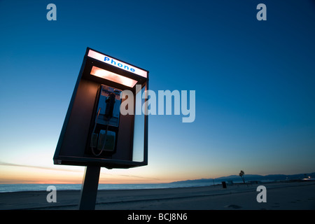 Pay telephone booth at beach with dusk sky in background Room for type Dockweiller Beach Los Angeles California USA Stock Photo