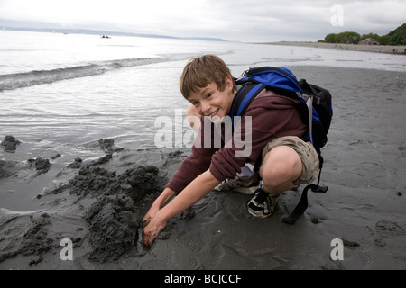 Boy Playing in the Sand Golden Gardens Park Seattle Washington Stock Photo