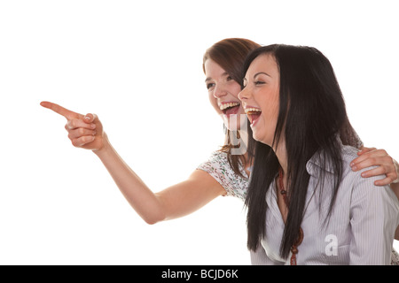 Two young girls see something very funny and laugh Stock Photo