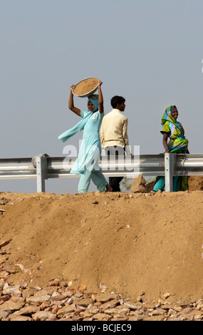 Woman in sari moves roadworks dirt Gujarat India Stock Photo