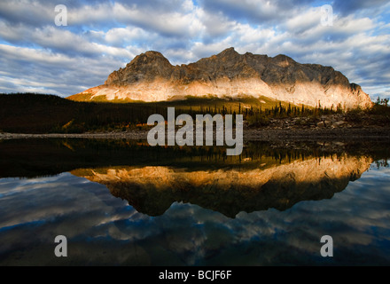 Late afternoon light on Sukakpak Mountain in the Brooks Range with a river in the foreground near the Dalton Highway, Alaska Stock Photo